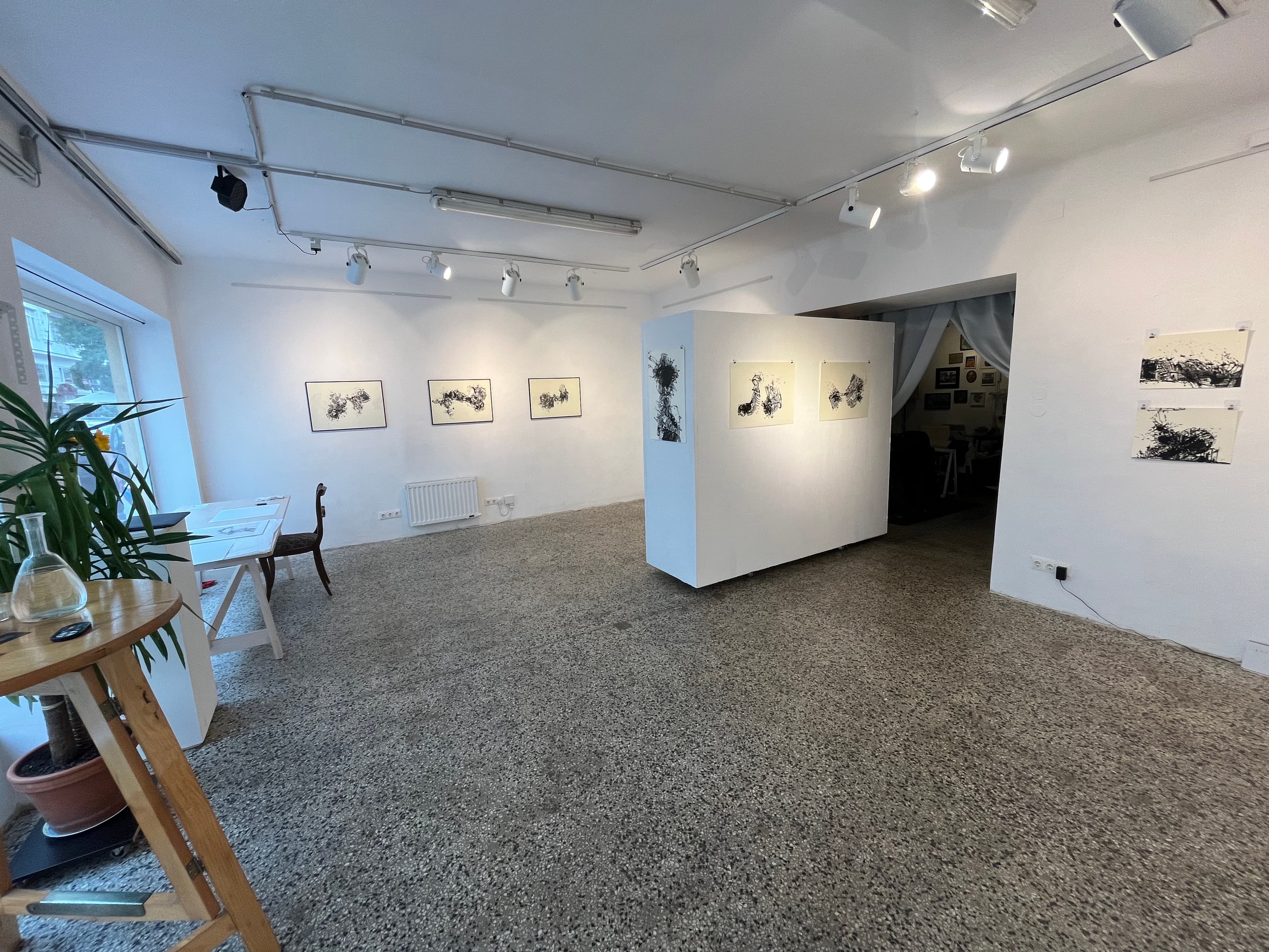 Gallery with black and white abstract paintings
